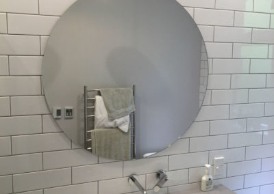 Round Glass Mirror installed in newly renovated bathroom.